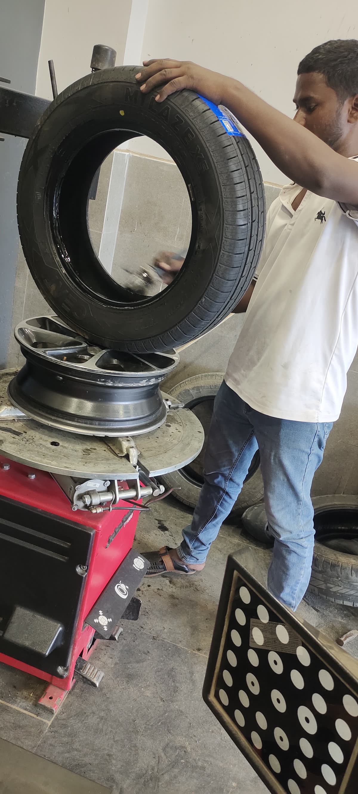 Technician fitting a tyre